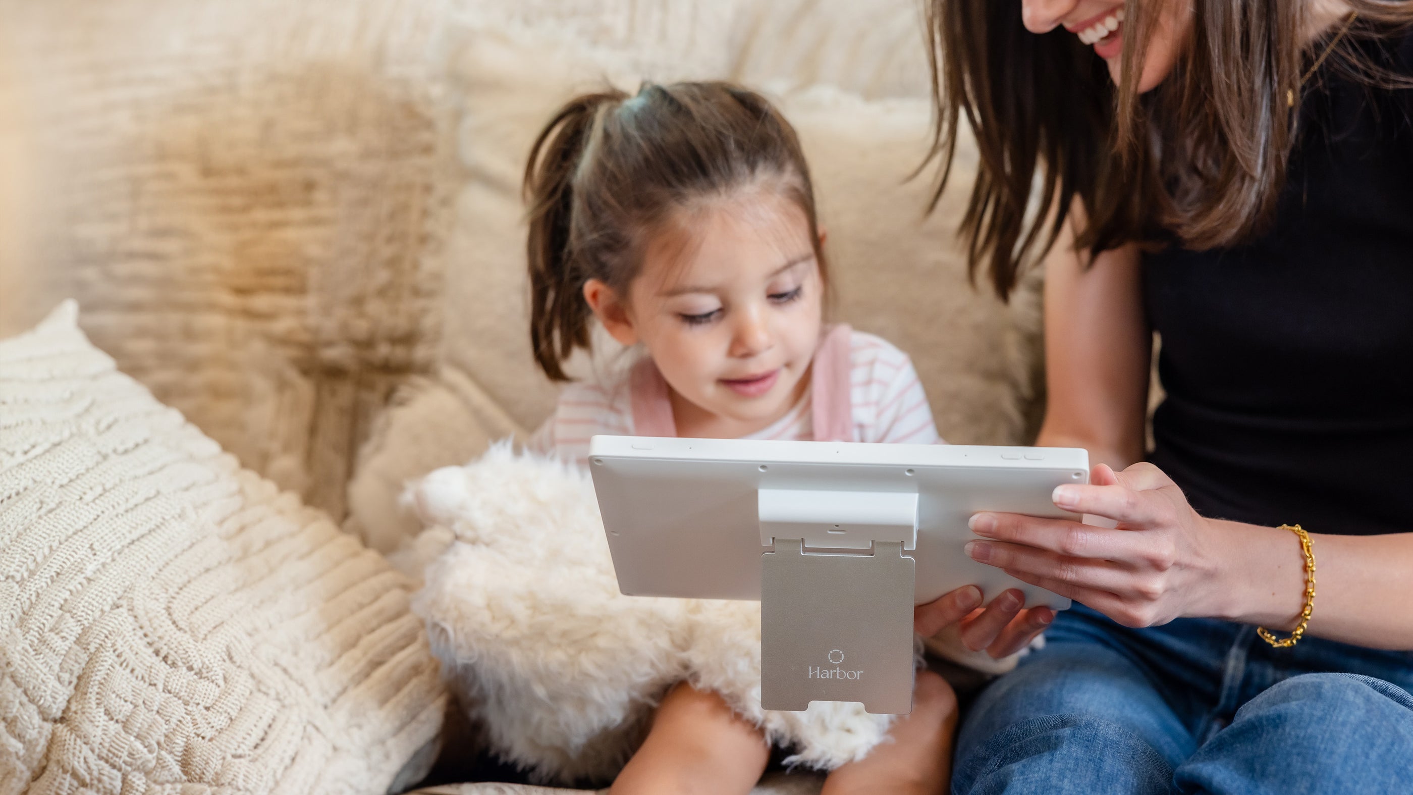 Toddle girl with mom holding a Harbor baby monitor