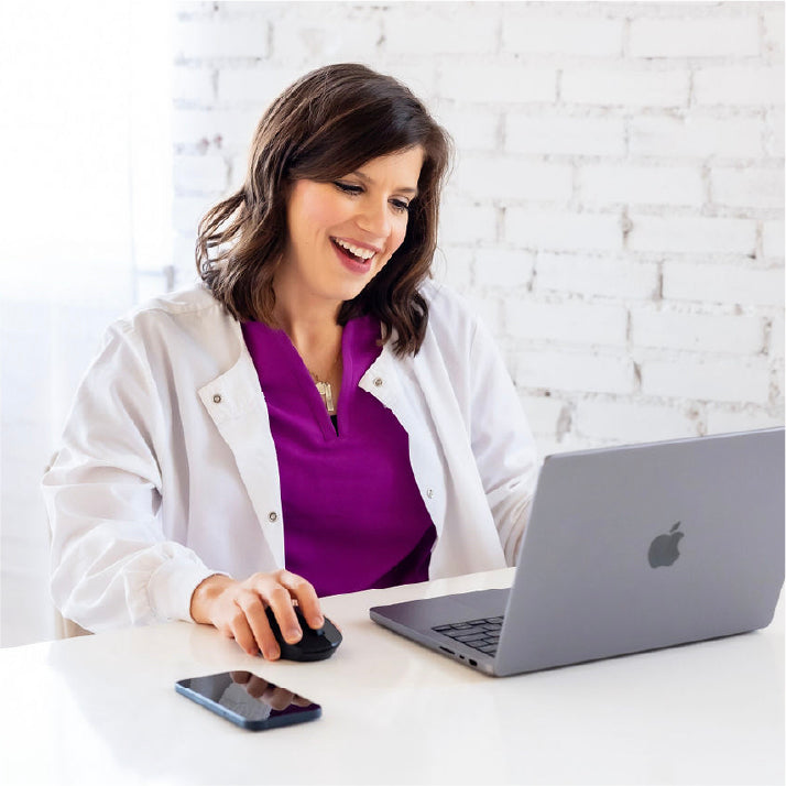 woman looking at laptop computer