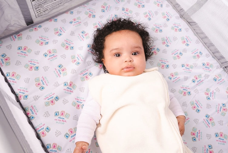 Baby in Pack In Play with Swaddle