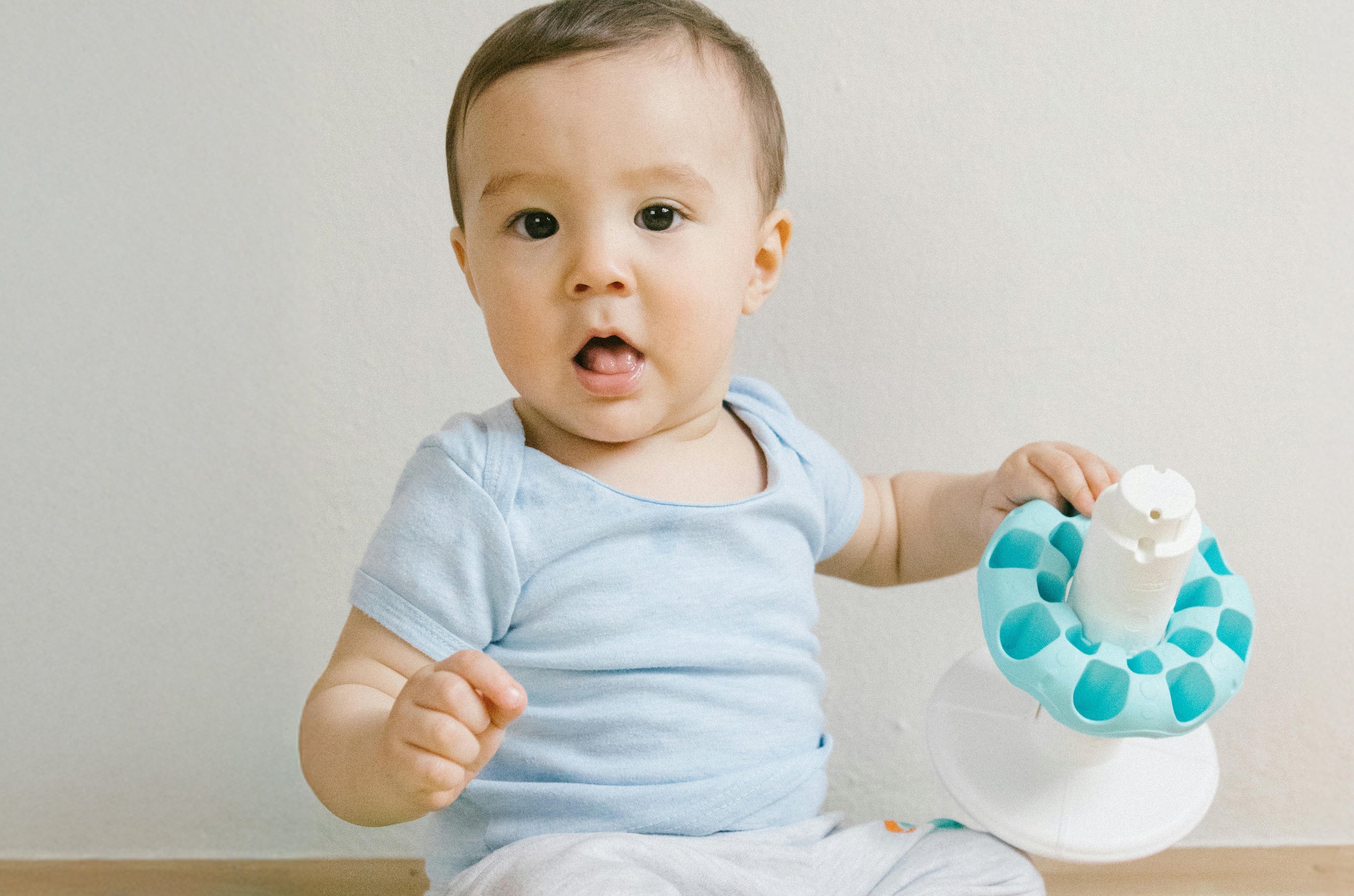 9 Month Old baby playing with a toy