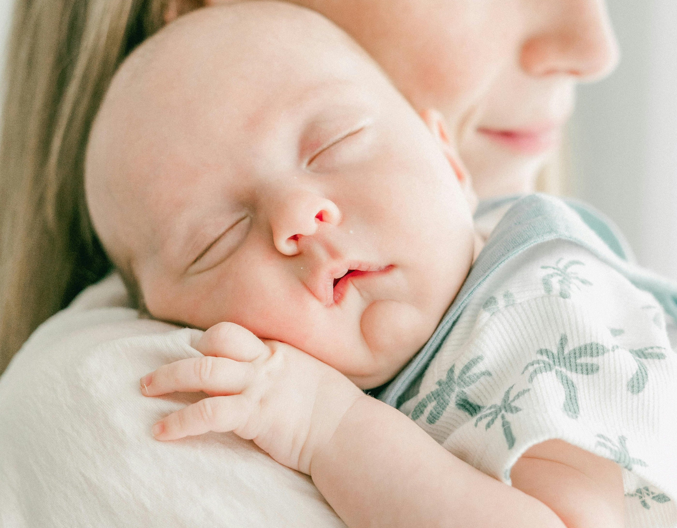 sleeping baby on mom's shoulder