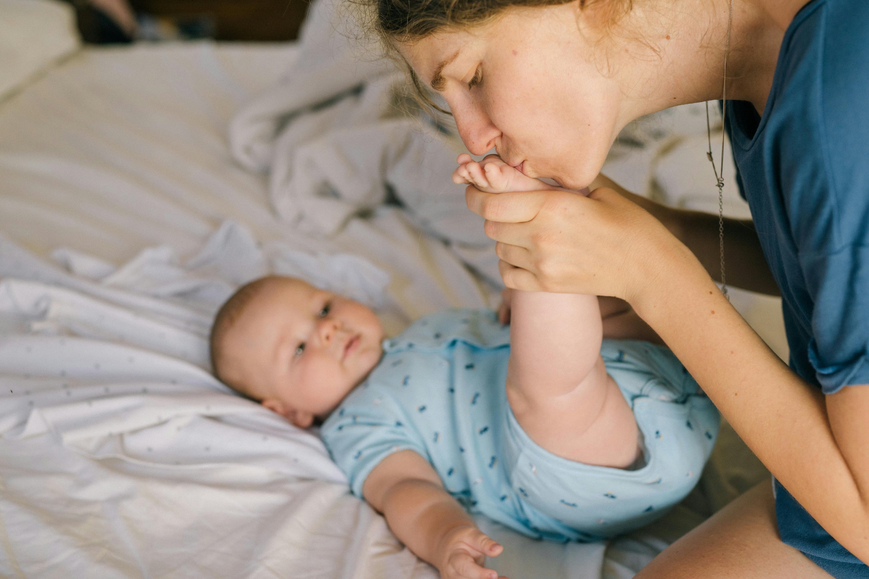 mom kissing baby's feet