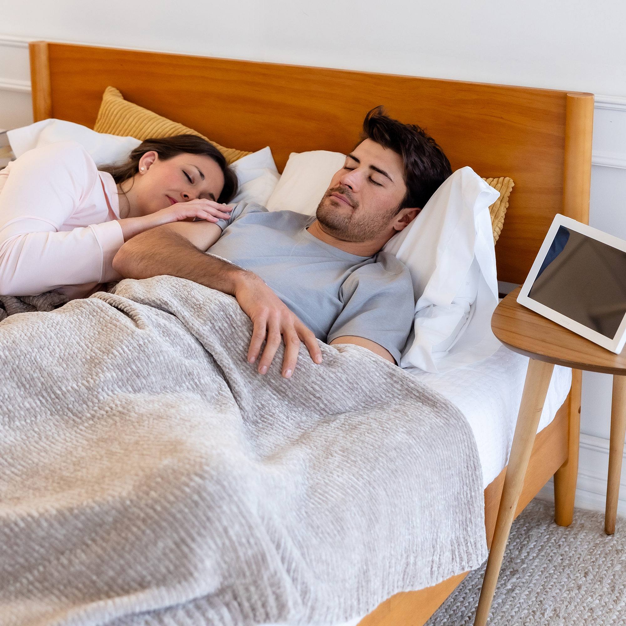 mom and dad asleep in bed with harbor monitor on night stand