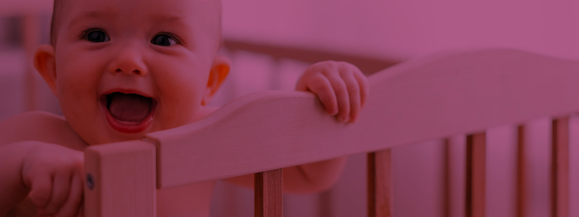 baby smiling in crib