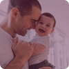 dad holding baby and laughing