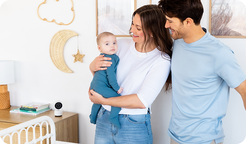 mom, dad, and baby in nursery